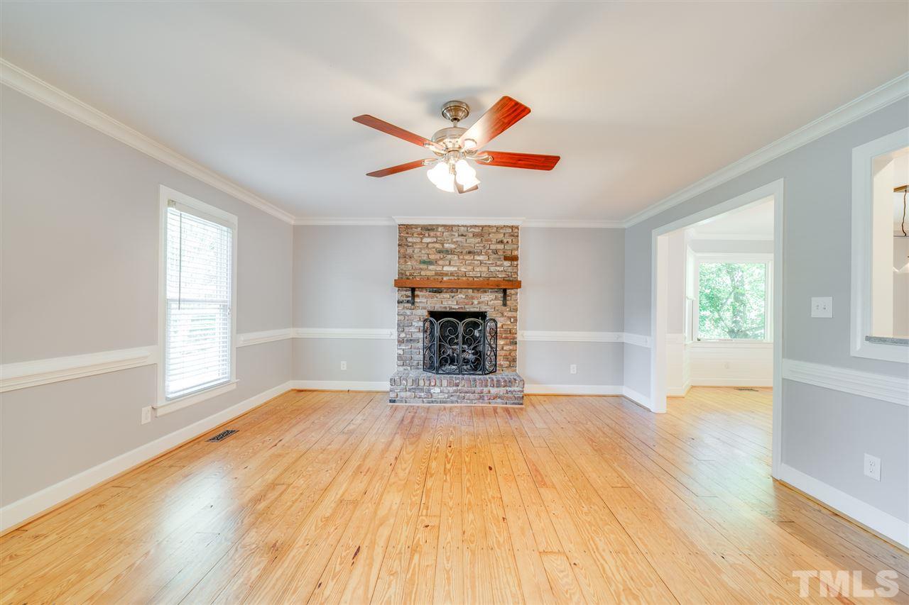 2116 Quail Ridge Road Raleigh, NC 27609 - Photo 5 of 30 a view of an empty room with window and wooden floor