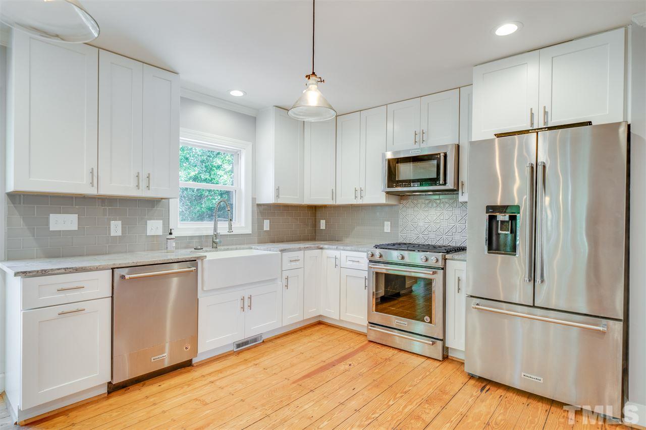 2116 Quail Ridge Road Raleigh, NC 27609 - Photo 6 of 30 a kitchen with a refrigerator stove and microwave