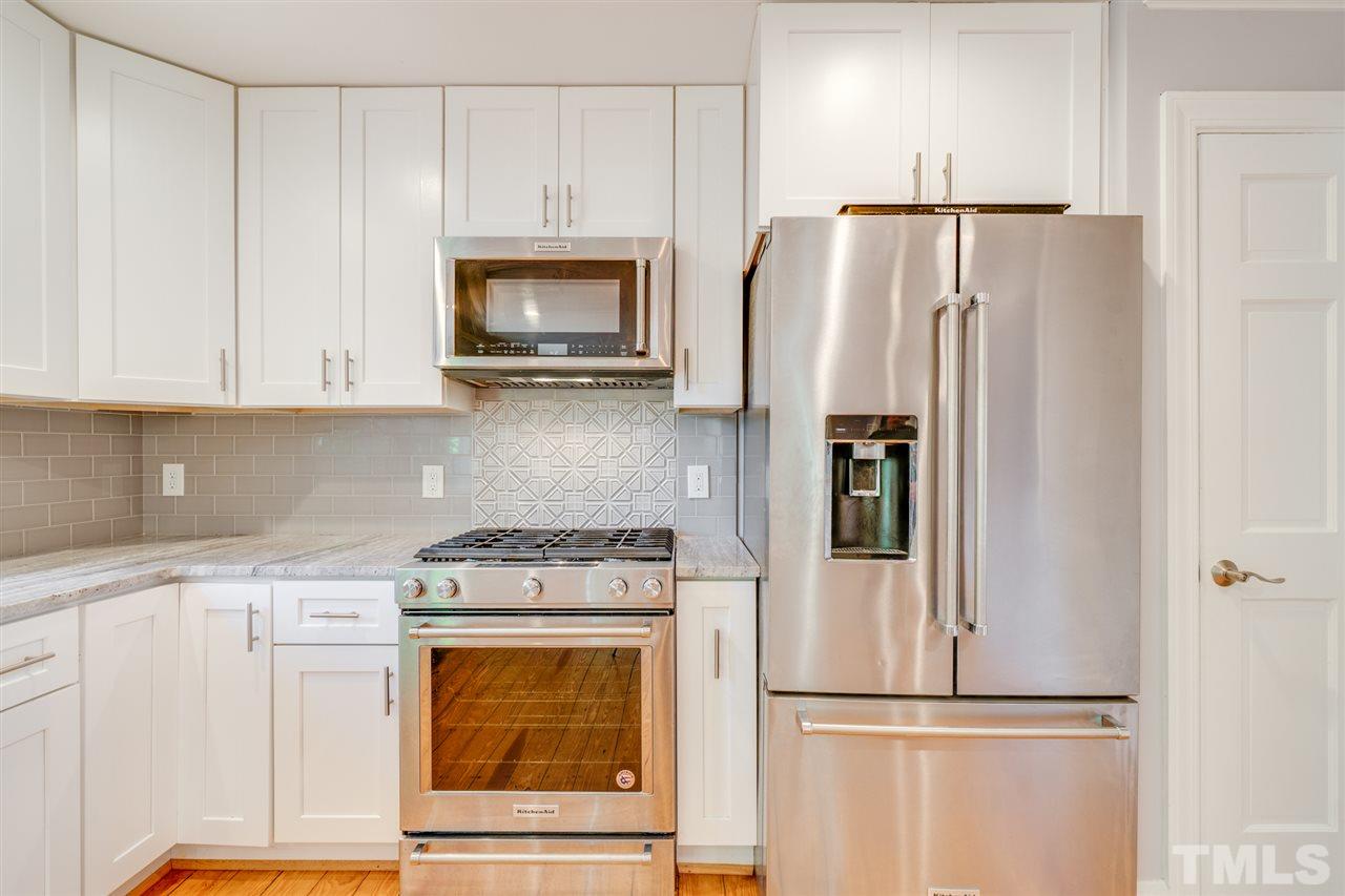 2116 Quail Ridge Road Raleigh, NC 27609 - Photo 8 of 30 a kitchen with appliances a refrigerator and cabinets
