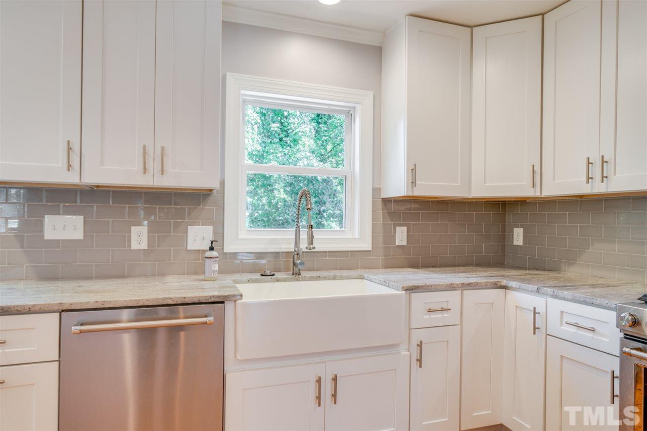 2116 Quail Ridge Road Raleigh, NC 27609 - Photo 9 of 30 a kitchen with stainless steel appliances granite countertop white cabinets sink and a granite counter top