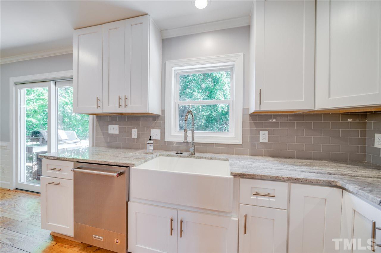 2116 Quail Ridge Road Raleigh, NC 27609 - Photo 10 of 30 a kitchen with granite countertop white cabinets and a window