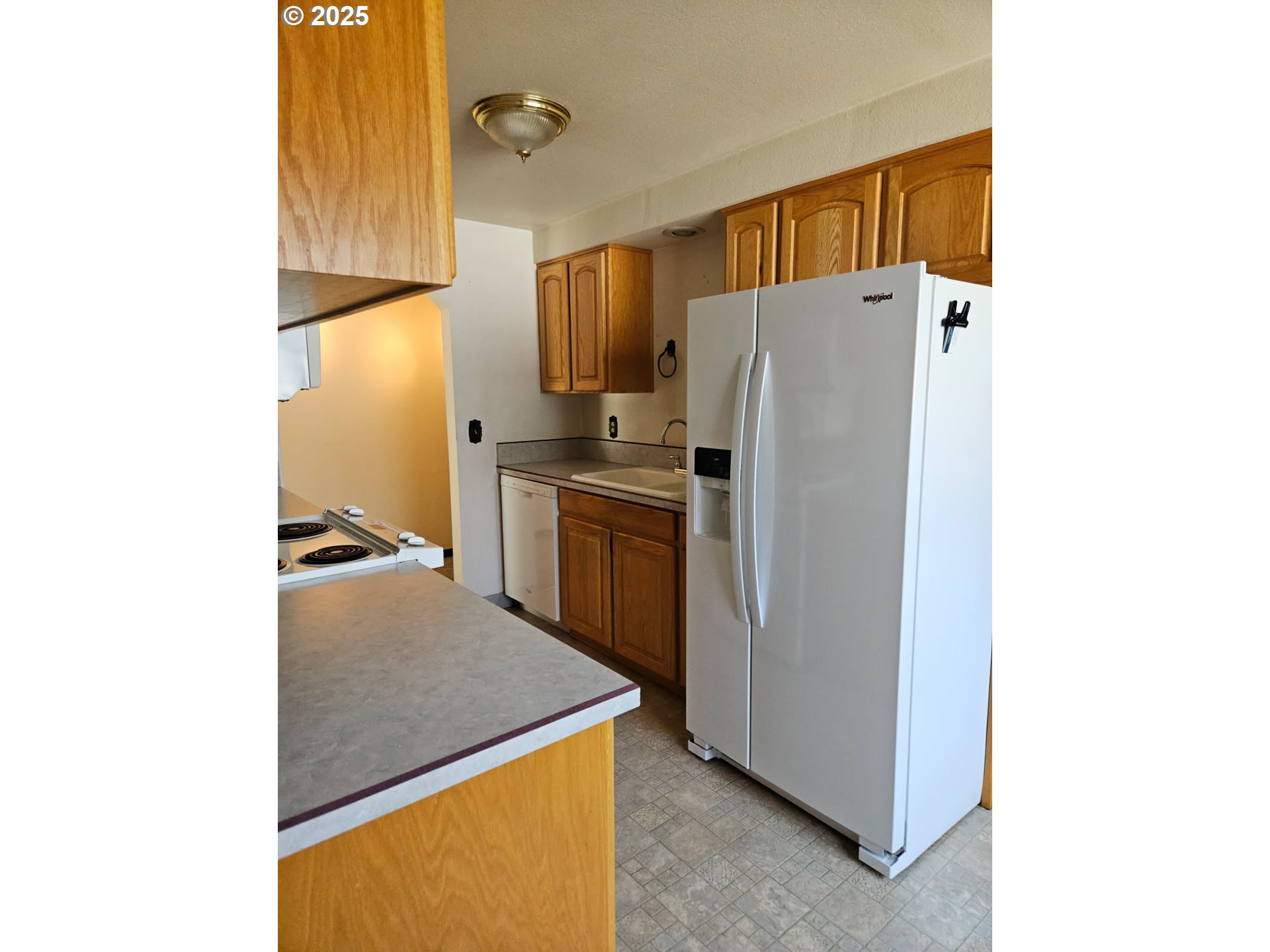 1179 Southeast Maple Place Gresham, OR 97080 - Photo 6 of 14 a kitchen with stainless steel appliances granite countertop a refrigerator a stove and a sink with cabinets
