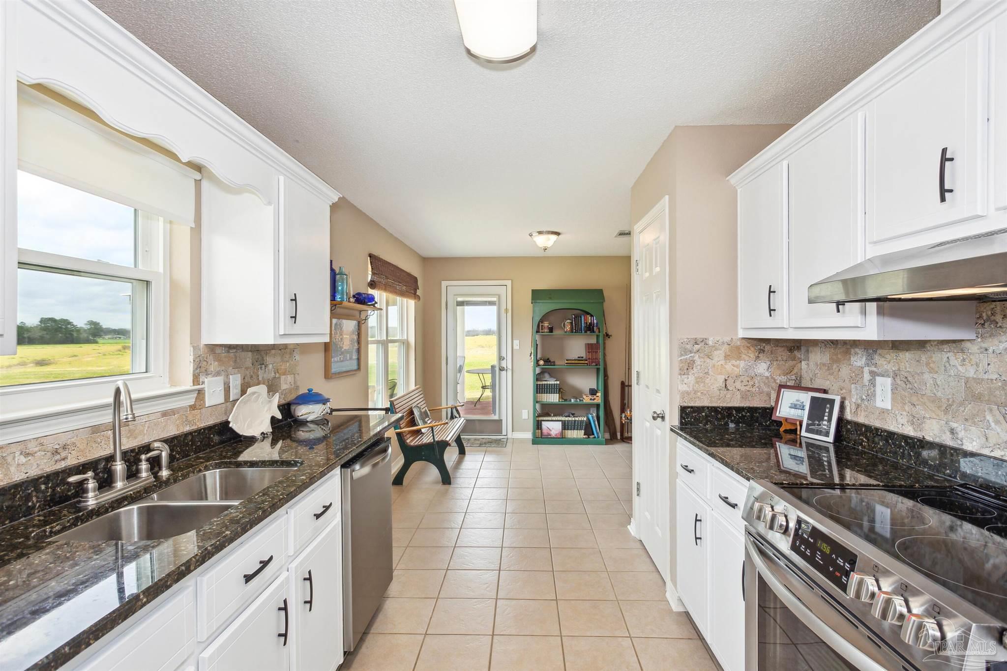 1911 Ard Field Road Jay, FL 32565 - Photo 11 of 47 a kitchen with granite countertop a sink stainless steel appliances and cabinets