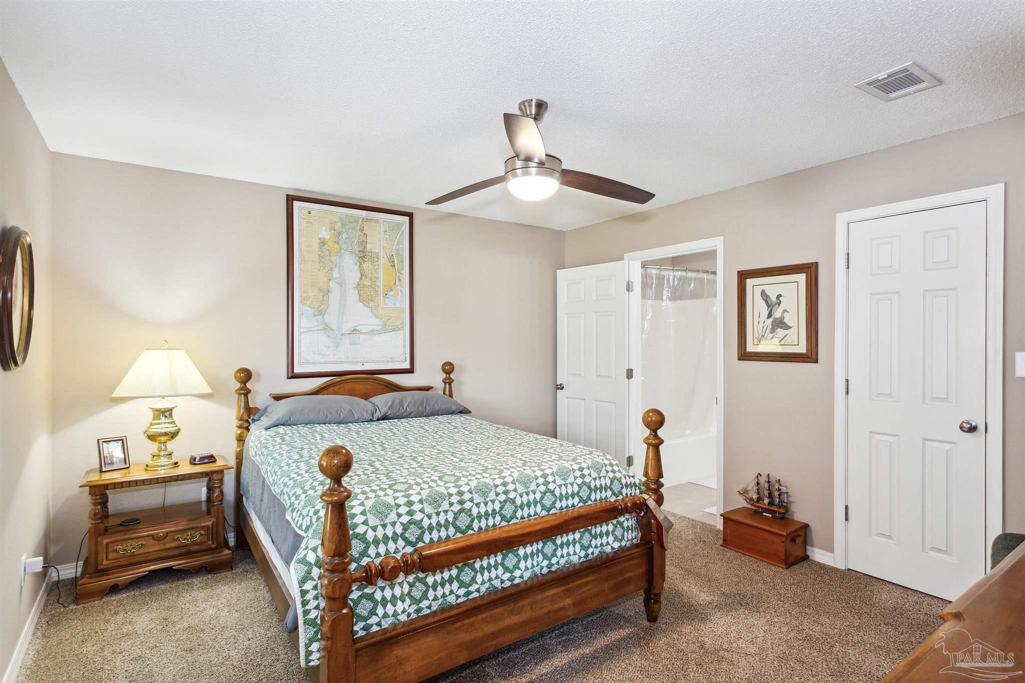 1911 Ard Field Road Jay, FL 32565 - Photo 17 of 47 a bedroom with a bed and a chandelier