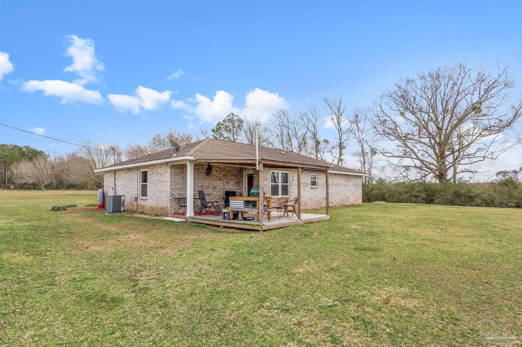1911 Ard Field Road Jay, FL 32565 - Photo 28 of 47 a view of a house with patio and garden