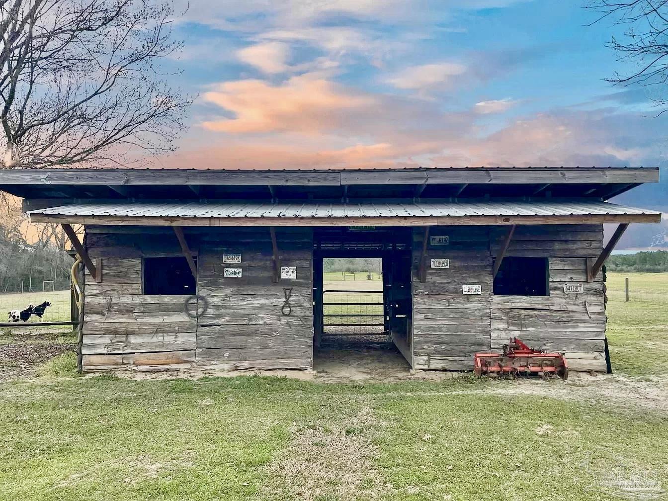 1911 Ard Field Road Jay, FL 32565 - Photo 34 of 47 a front view of a house with a garden