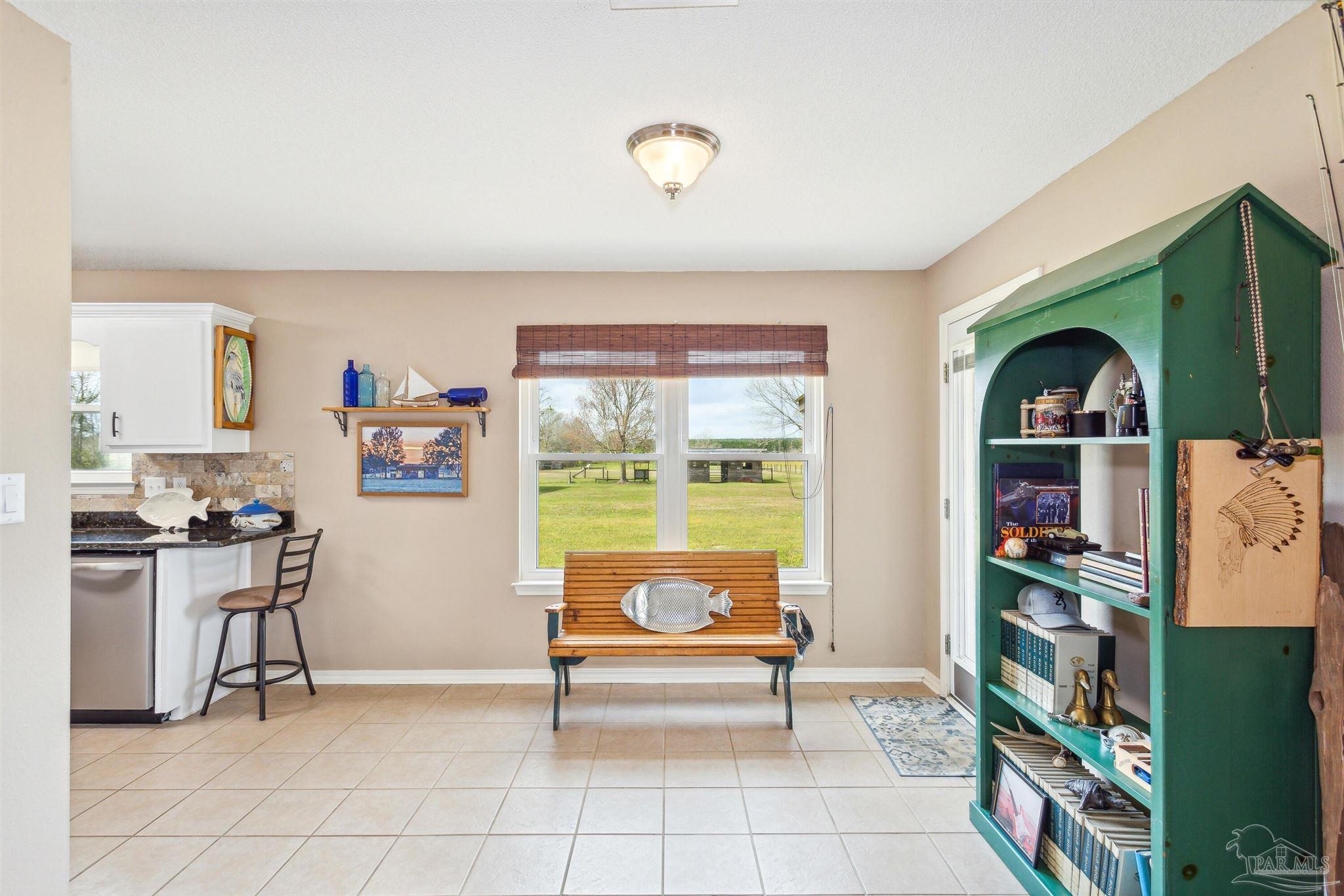1911 Ard Field Road Jay, FL 32565 - Photo 10 of 47 a living room with furniture and a book shelf