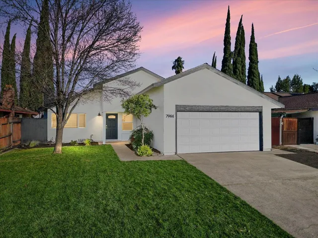 a view of a house with a yard and garage