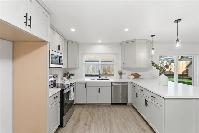 a kitchen with white cabinets sink and white appliances