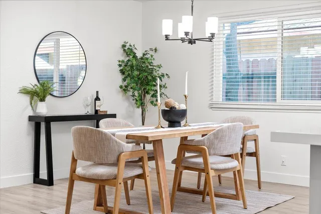 a dining room with furniture and a window