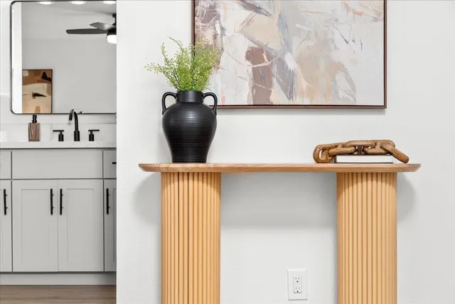 a vase of flowers sitting on a table near a window