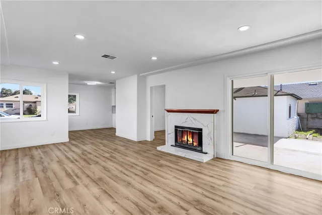 a view of a livingroom with a fireplace and wooden floor