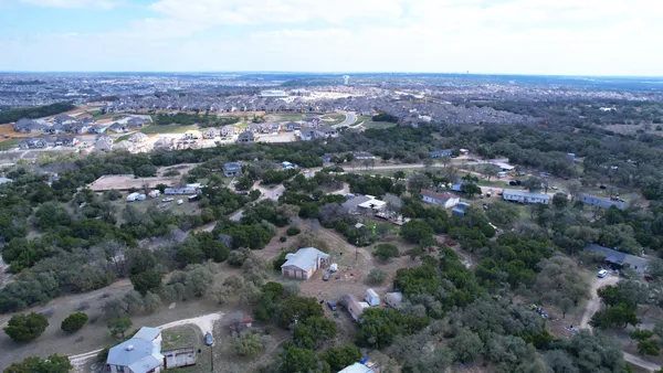 an aerial view of residential building with green space