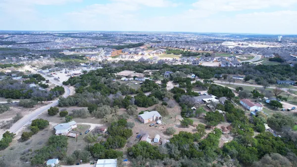an aerial view of residential building with green space