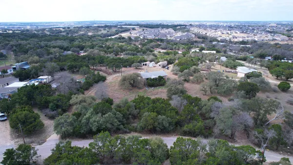 an aerial view of residential house with green space