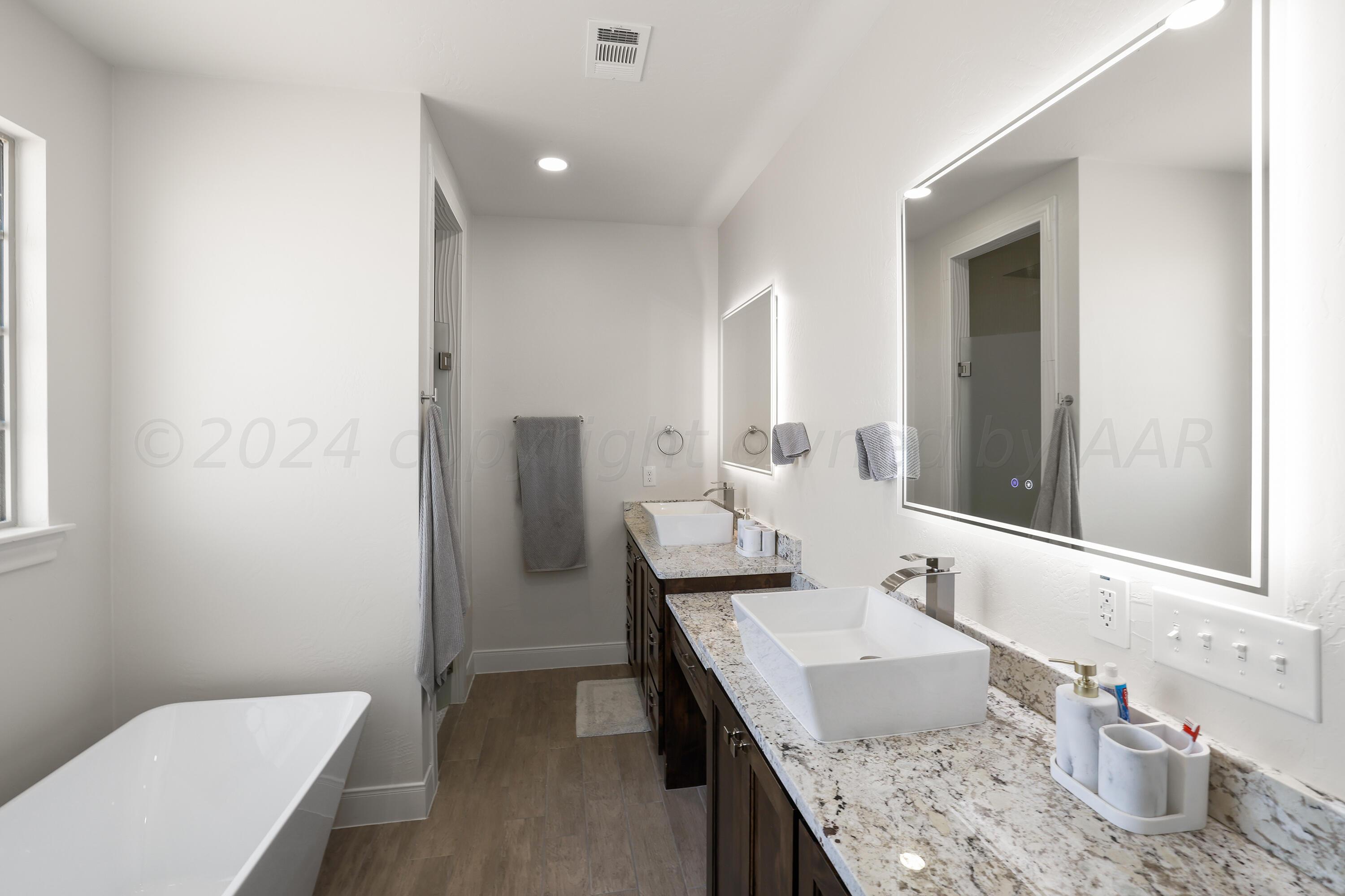 50 South Fm 2381 Amarillo, TX 79124 - Photo 14 of 31 a bathroom with a granite countertop sink a toilet and mirror