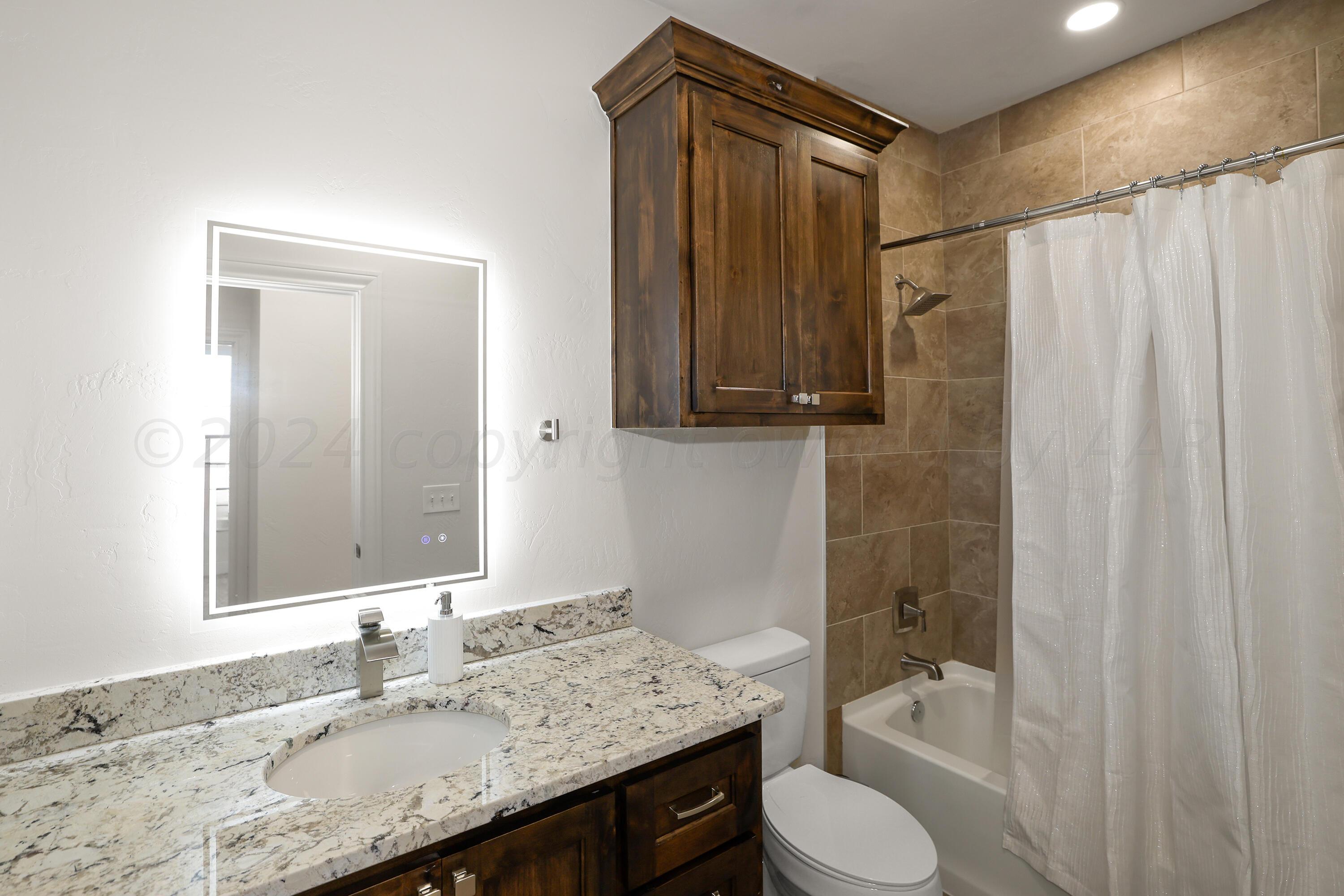 50 South Fm 2381 Amarillo, TX 79124 - Photo 20 of 31 a bathroom with a granite countertop sink toilet and shower
