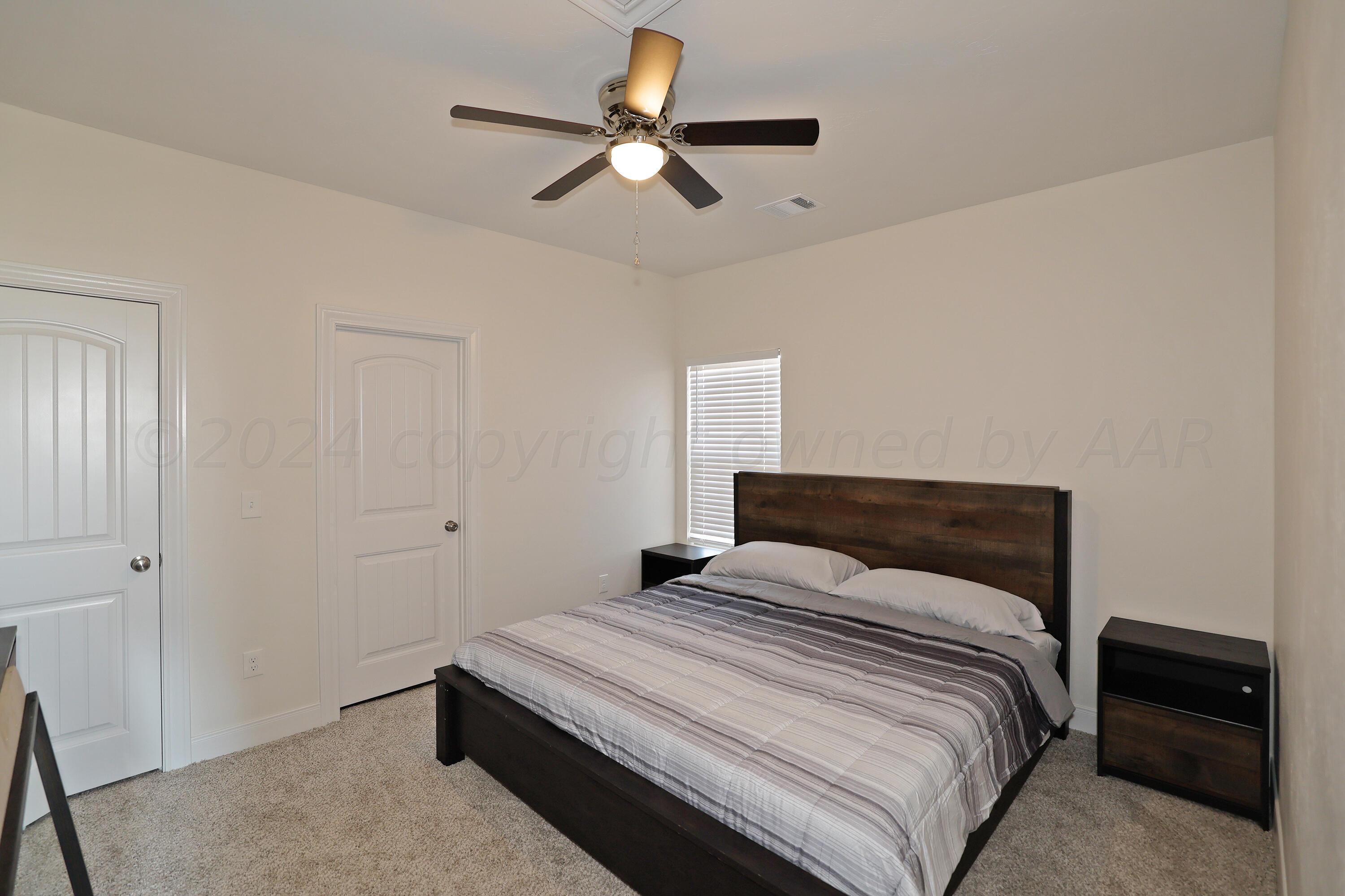 50 South Fm 2381 Amarillo, TX 79124 - Photo 23 of 31 a bedroom with a bed and a chandelier