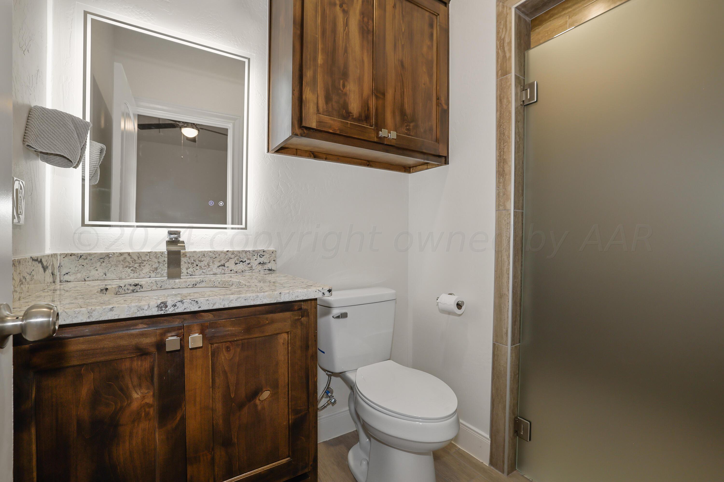 50 South Fm 2381 Amarillo, TX 79124 - Photo 25 of 31 a bathroom with a granite countertop toilet sink and mirror