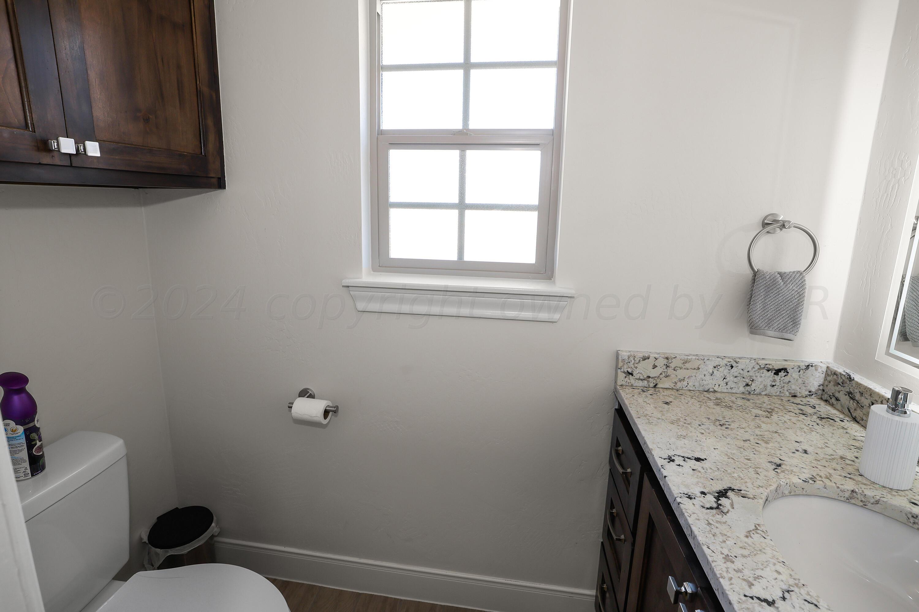 50 South Fm 2381 Amarillo, TX 79124 - Photo 27 of 31 a bathroom with a granite countertop sink a toilet and a window