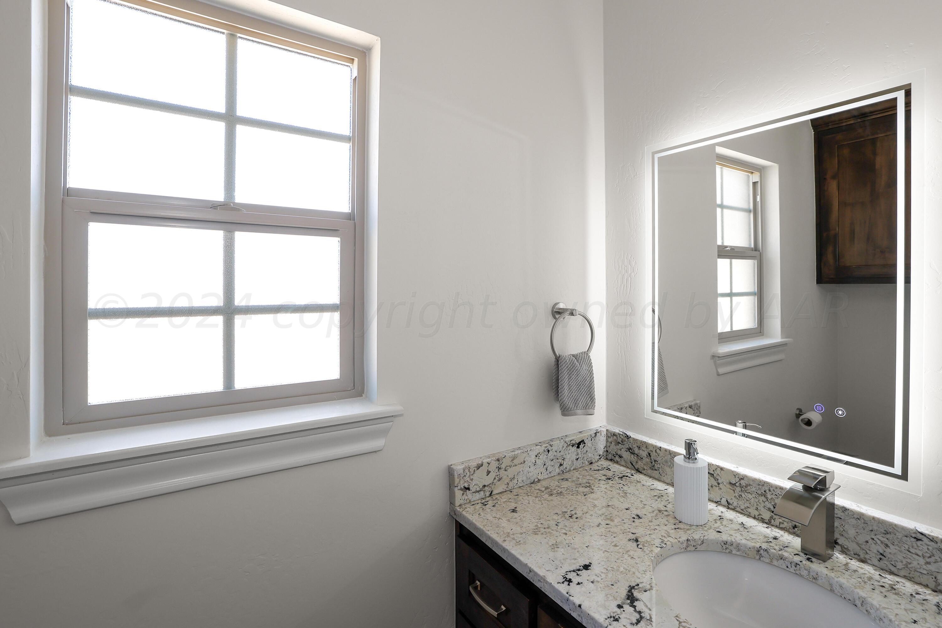 50 South Fm 2381 Amarillo, TX 79124 - Photo 28 of 31 a bathroom with a granite countertop sink and a window