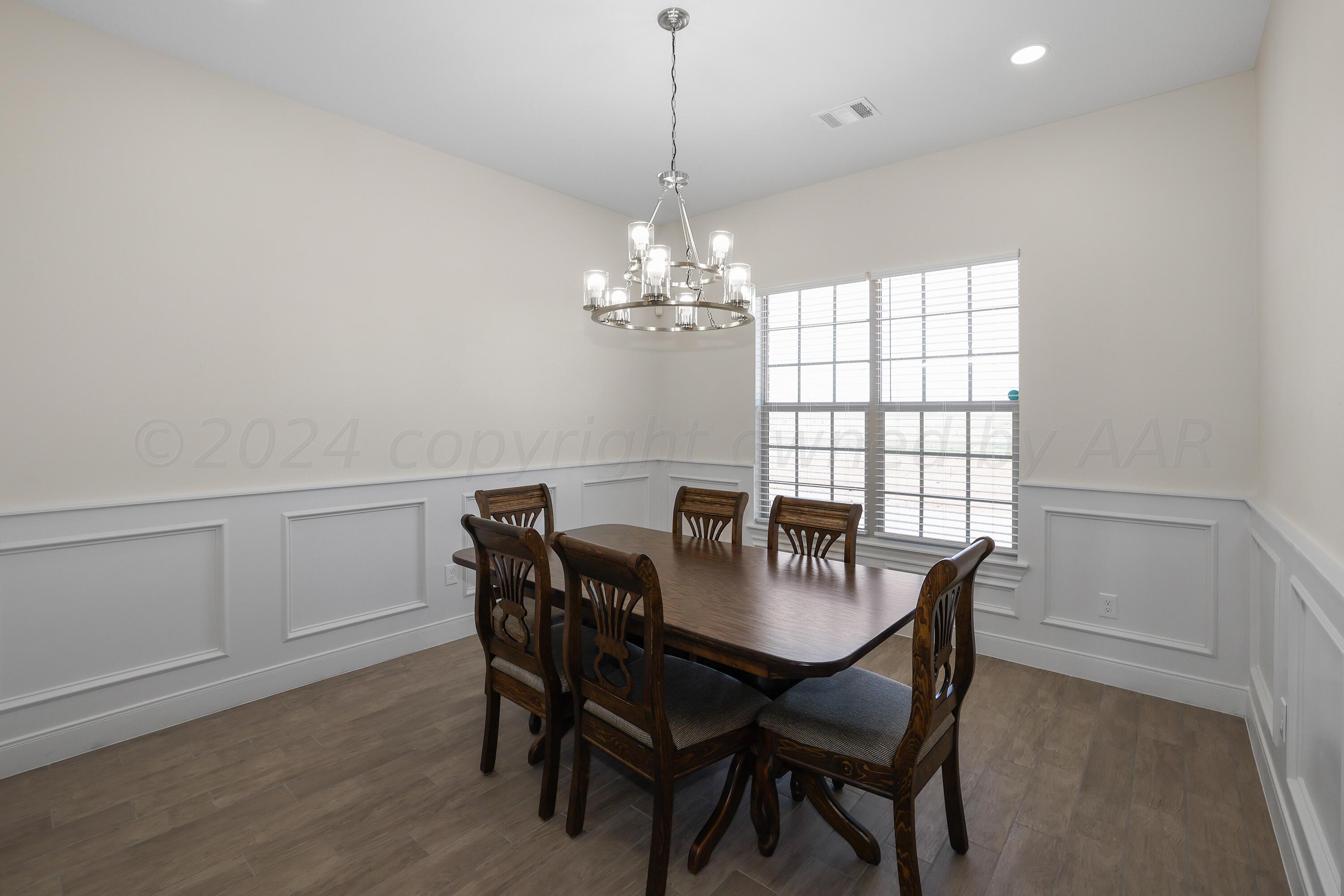 50 South Fm 2381 Amarillo, TX 79124 - Photo 7 of 31 a dining room with furniture a chandelier and wooden floor
