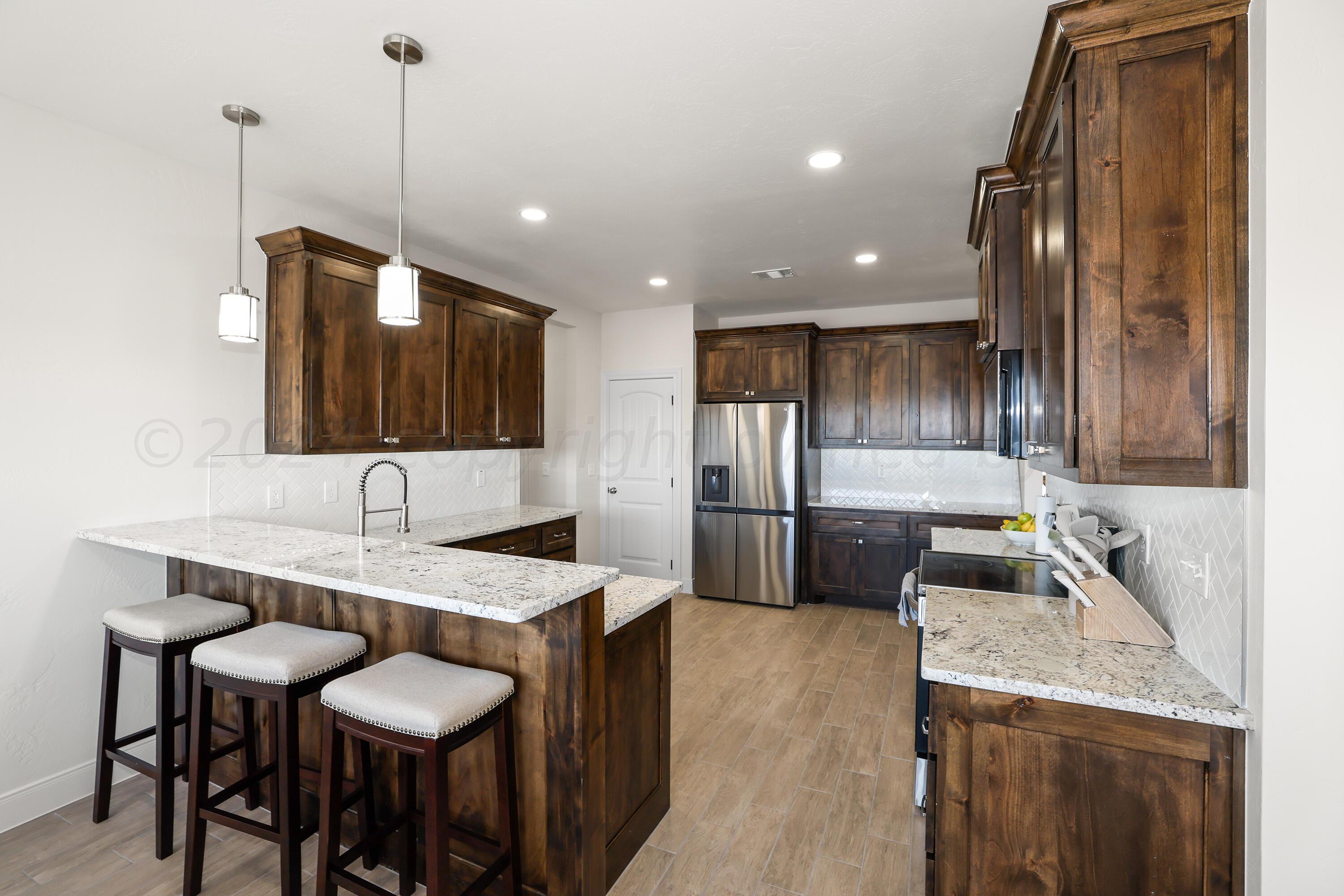 50 South Fm 2381 Amarillo, TX 79124 - Photo 9 of 31 a kitchen with granite countertop a sink a counter top space stainless steel appliances and cabinets