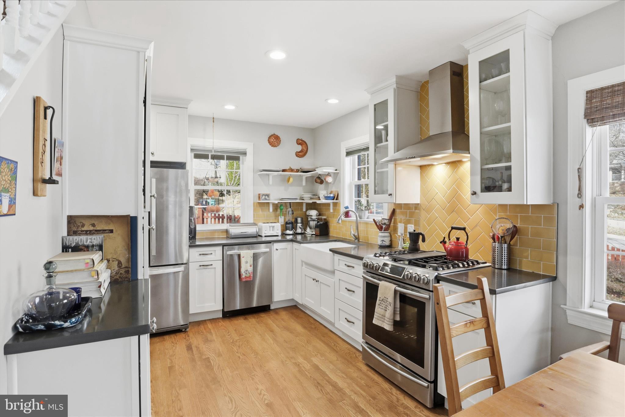 304 Highview Avenue Silver Spring, MD 20901 - Photo 13 of 48 a kitchen with stainless steel appliances granite countertop a stove top oven a sink a refrigerator and white cabinets with wooden floor