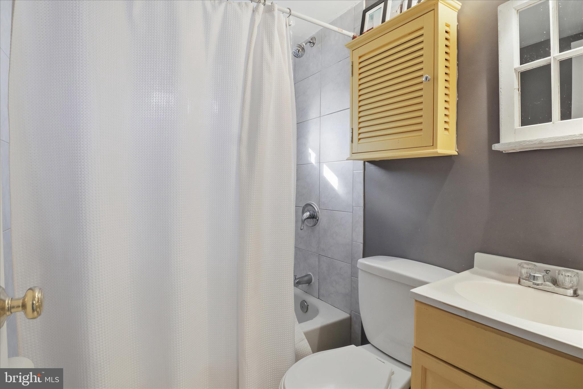 304 Highview Avenue Silver Spring, MD 20901 - Photo 30 of 48 a white toilet sitting next to a bathroom sink and vanity