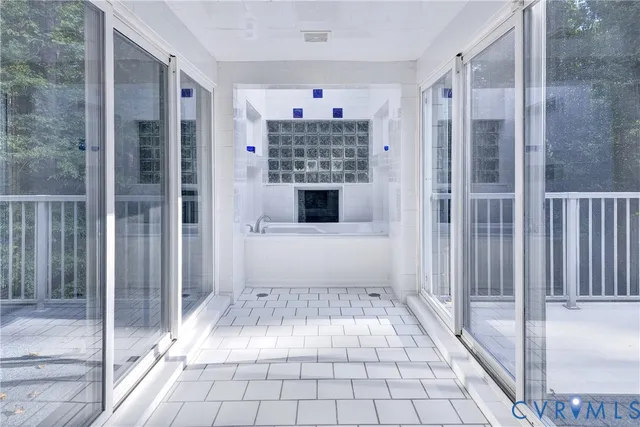 a living room with a large window and chandelier