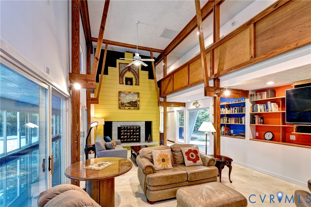 8615 Historical Path Road New Kent, VA 23124 - Photo 3 of 50 a living room with fireplace furniture and a book shelf