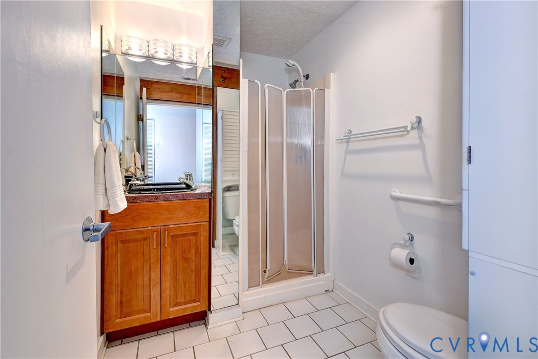 8615 Historical Path Road New Kent, VA 23124 - Photo 31 of 50 a bathroom with a granite countertop sink and a mirror