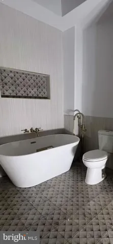 a bathroom with a bathtub and toilet