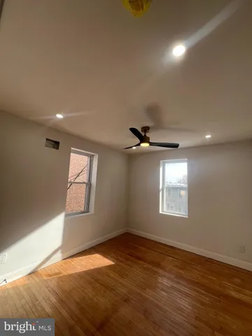 an empty room with windows and closet