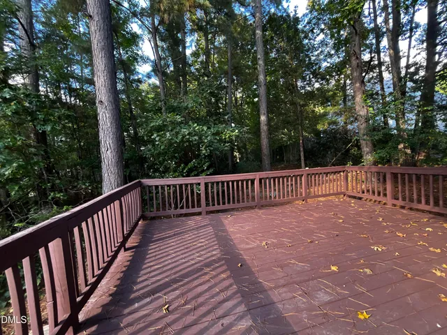 a balcony with wooden floor in front of it