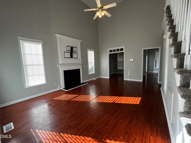 wooden floor in an empty room with a fireplace