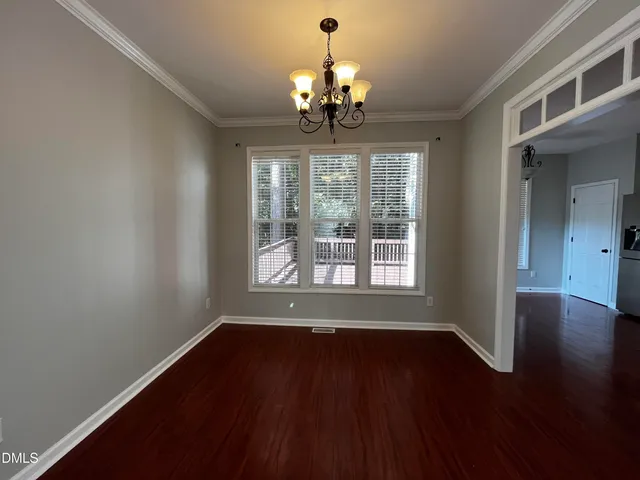a view of wooden floor and a chandelier in a room