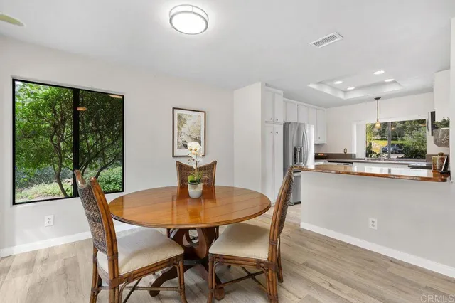 a view of a dining room with furniture and a potted plant