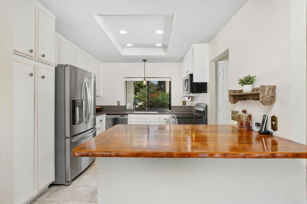 4119 Oak Island Lane Fallbrook, CA 92028 - Photo 16 of 54 a kitchen with stainless steel appliances granite countertop a refrigerator a stove and a sink