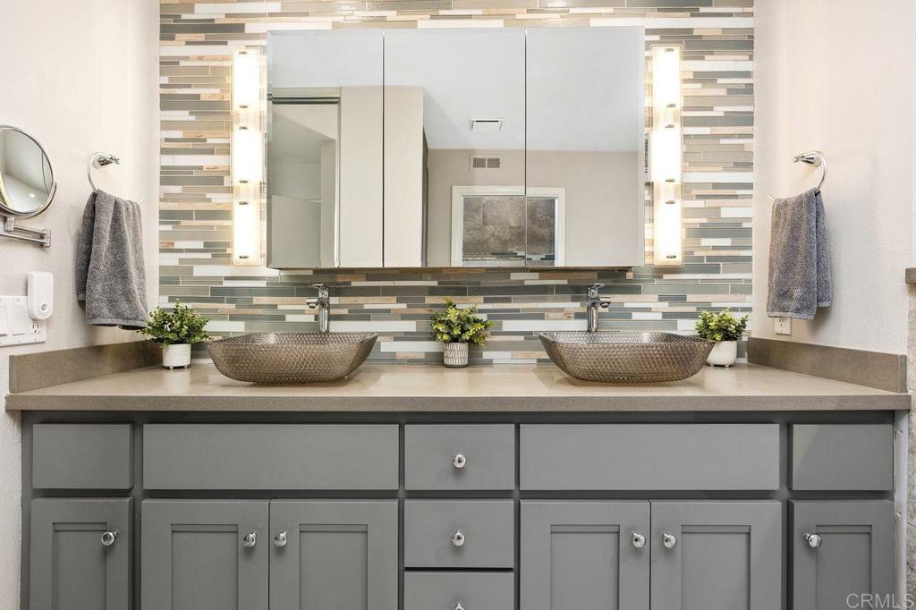 4119 Oak Island Lane Fallbrook, CA 92028 - Photo 28 of 54 a bathroom with a granite countertop sink and a mirror