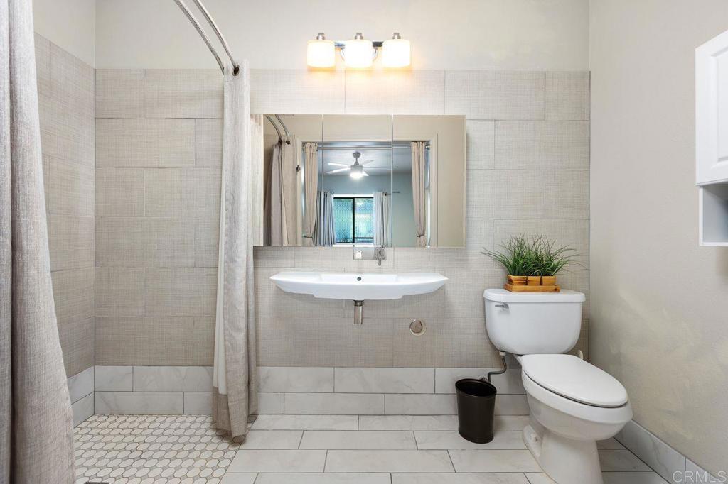 4119 Oak Island Lane Fallbrook, CA 92028 - Photo 36 of 54 a bathroom with a sink toilet and shower