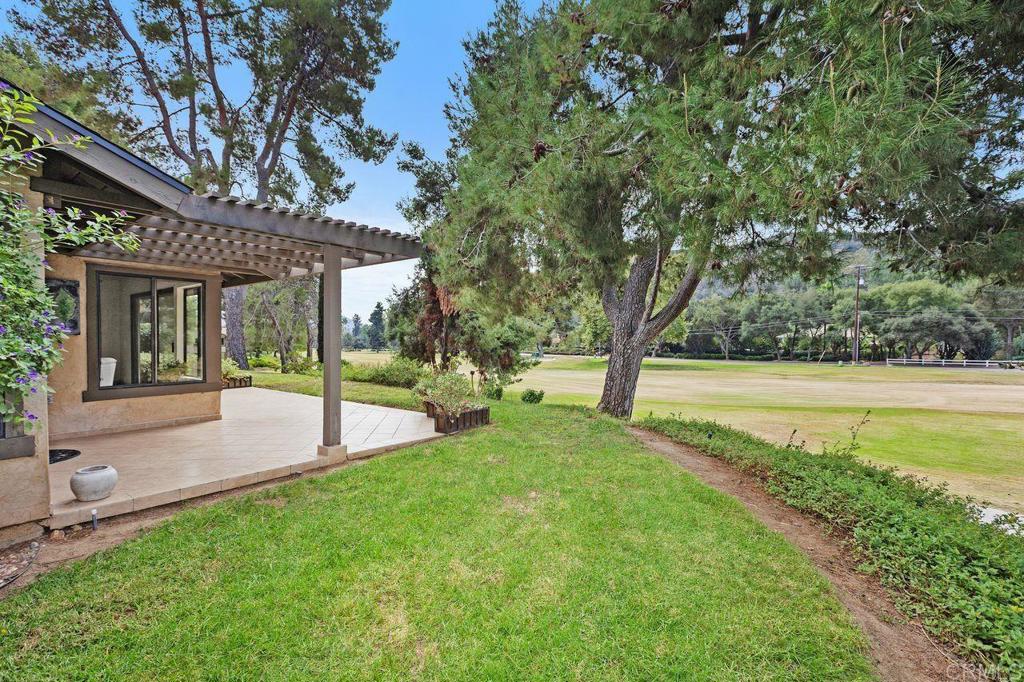 4119 Oak Island Lane Fallbrook, CA 92028 - Photo 37 of 54 a view of a house with a backyard and a large tree