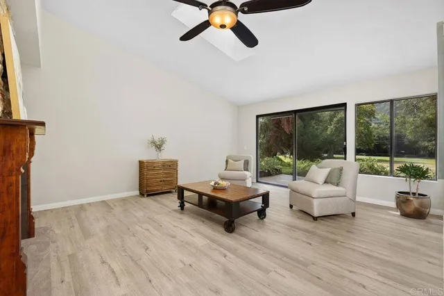 a living room with furniture and a floor to ceiling window