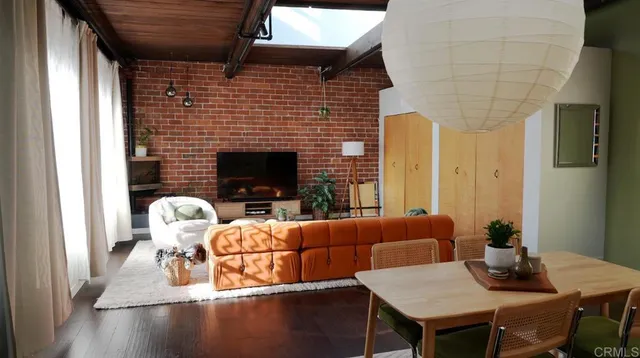 a living room with furniture wooden floor and a fireplace
