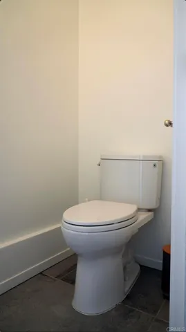 a white toilet sitting next to a white sink