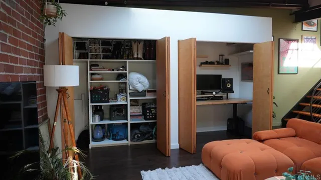 a kitchen with stainless steel appliances a refrigerator and wooden floor