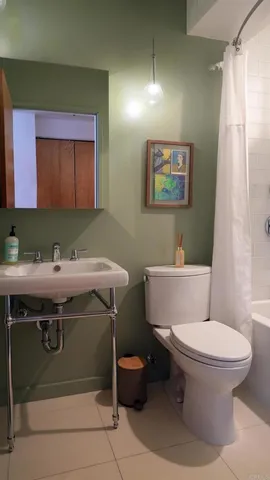 a bathroom with a sink toilet and mirror