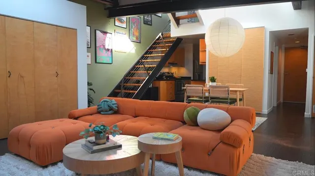 a living room with furniture and wooden floor