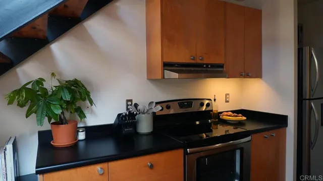 a kitchen with a sink a stove and cabinets