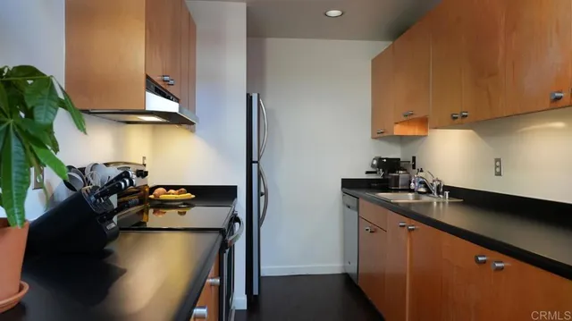 a kitchen with a sink appliances and cabinets